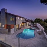 a view of a house with backyard porch and sitting area