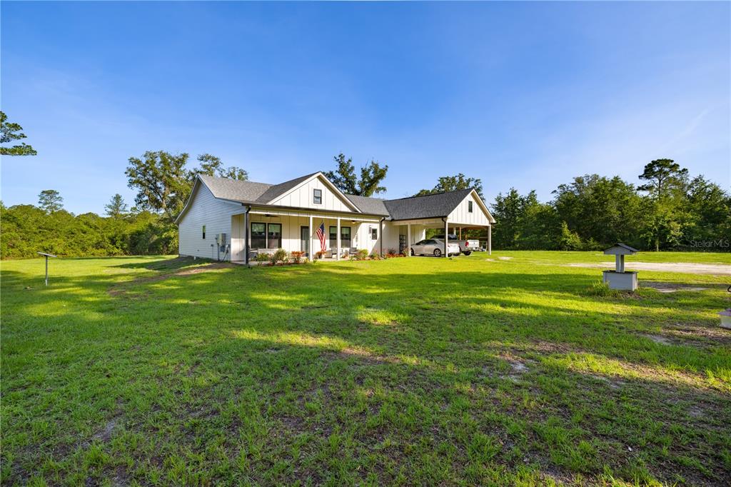 5149 Southwest 119th Road Lake Butler, FL 32054 - Photo 33 of 40 a front view of a house with garden