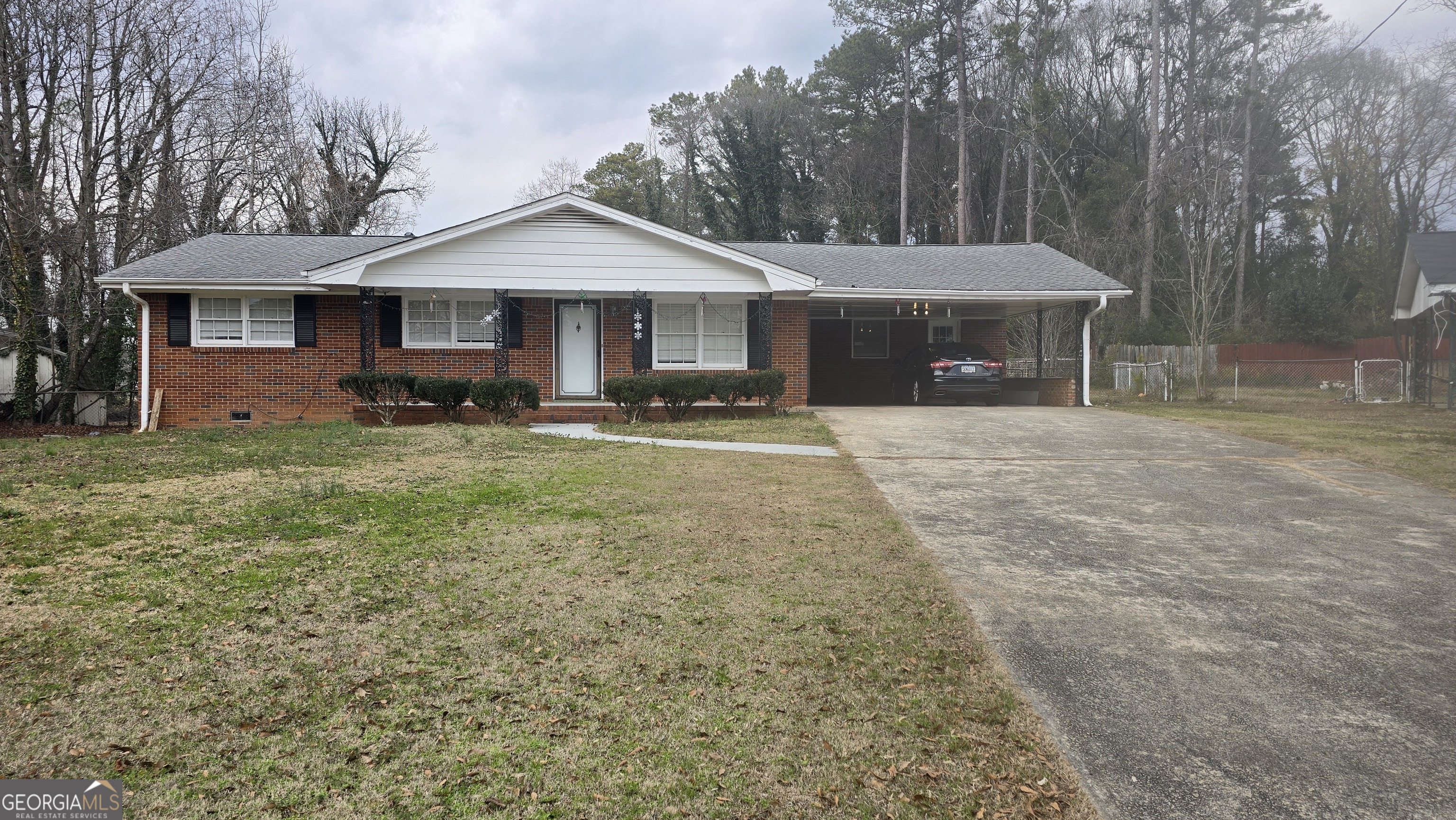 6359 Lanier Road Morrow, GA 30260 - Photo 1 of 15 a front view of a house with garden