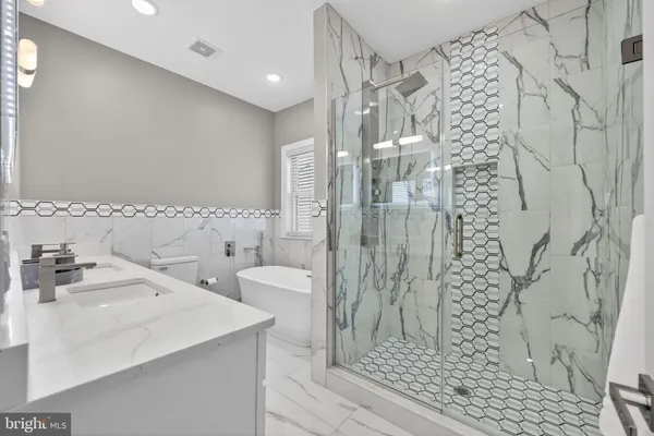 a white bath tub sitting next to a white toilet