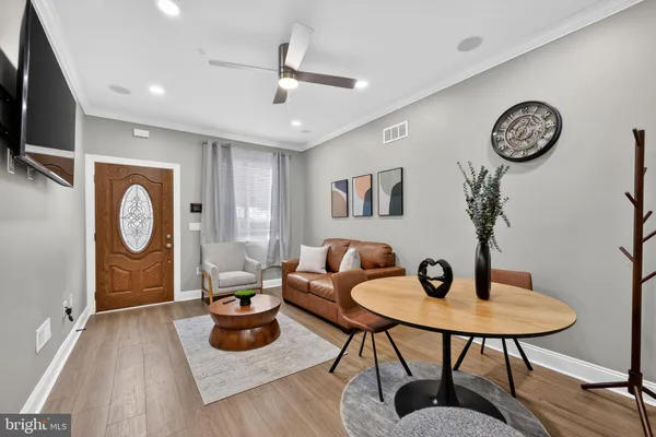 a view of a hallway with furniture and wooden floor