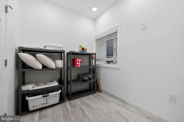 a view of a hallway with wooden floor and entryway