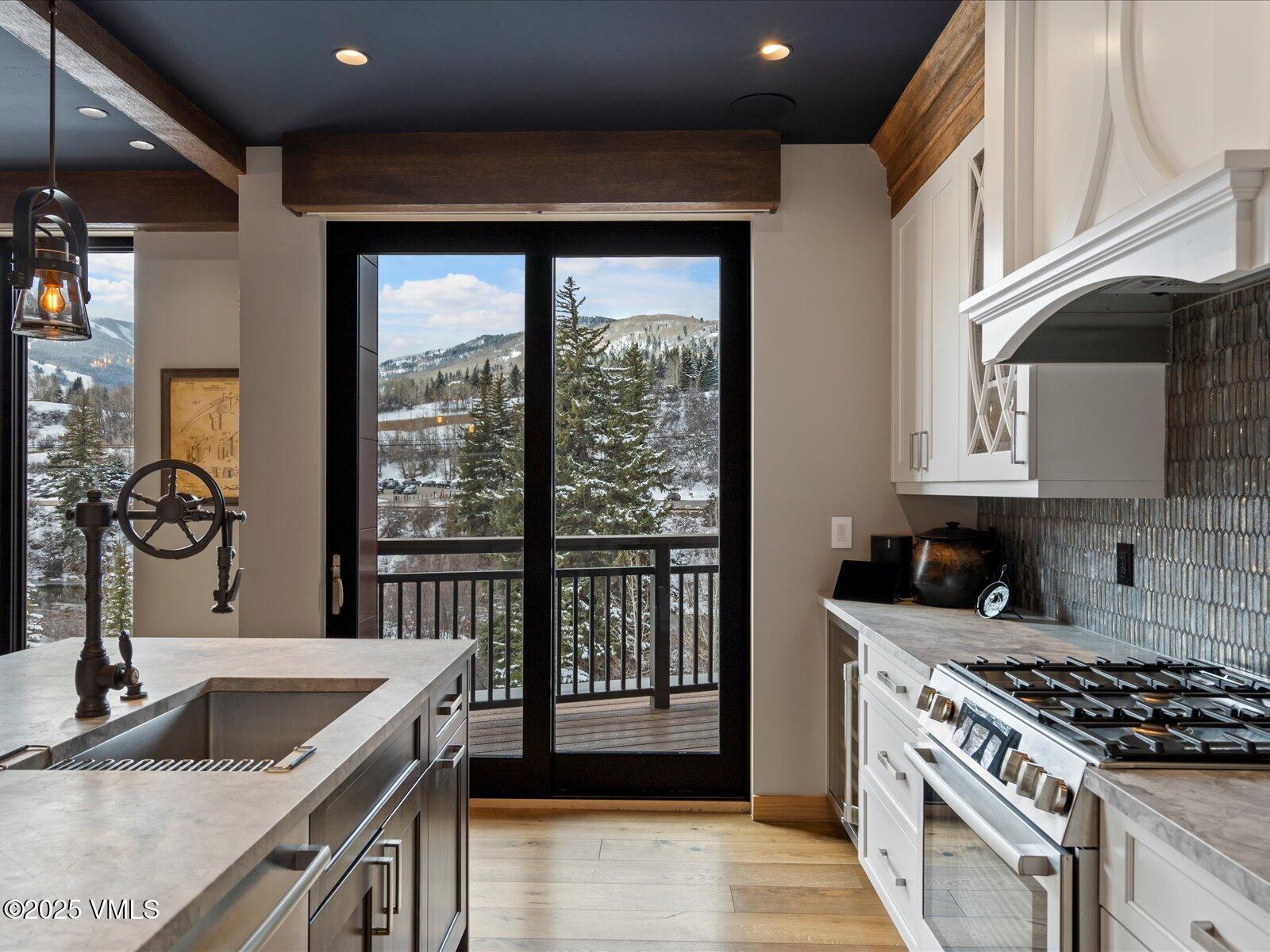 1 Waterfront Way, Unit 204 Avon, CO 81620 - Photo 12 of 38 a kitchen with granite countertop a sink and a stove top oven