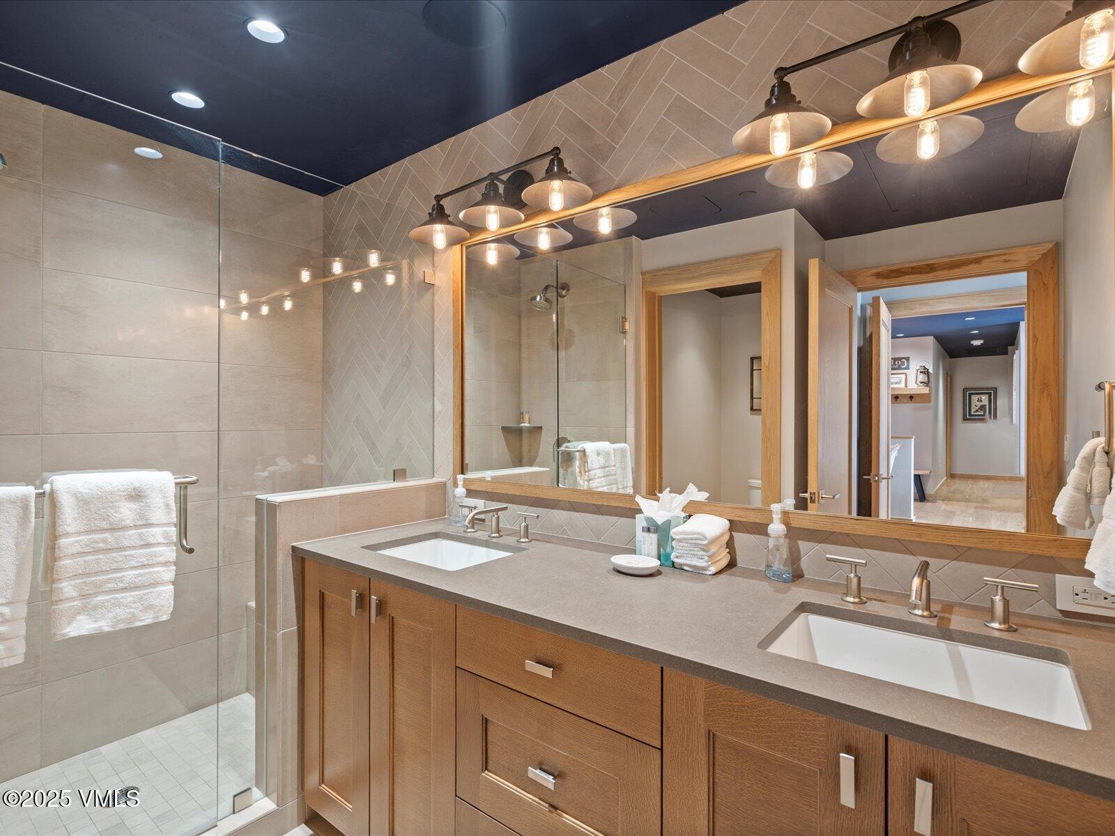 1 Waterfront Way, Unit 204 Avon, CO 81620 - Photo 21 of 38 a bathroom with a double vanity sink and a mirror