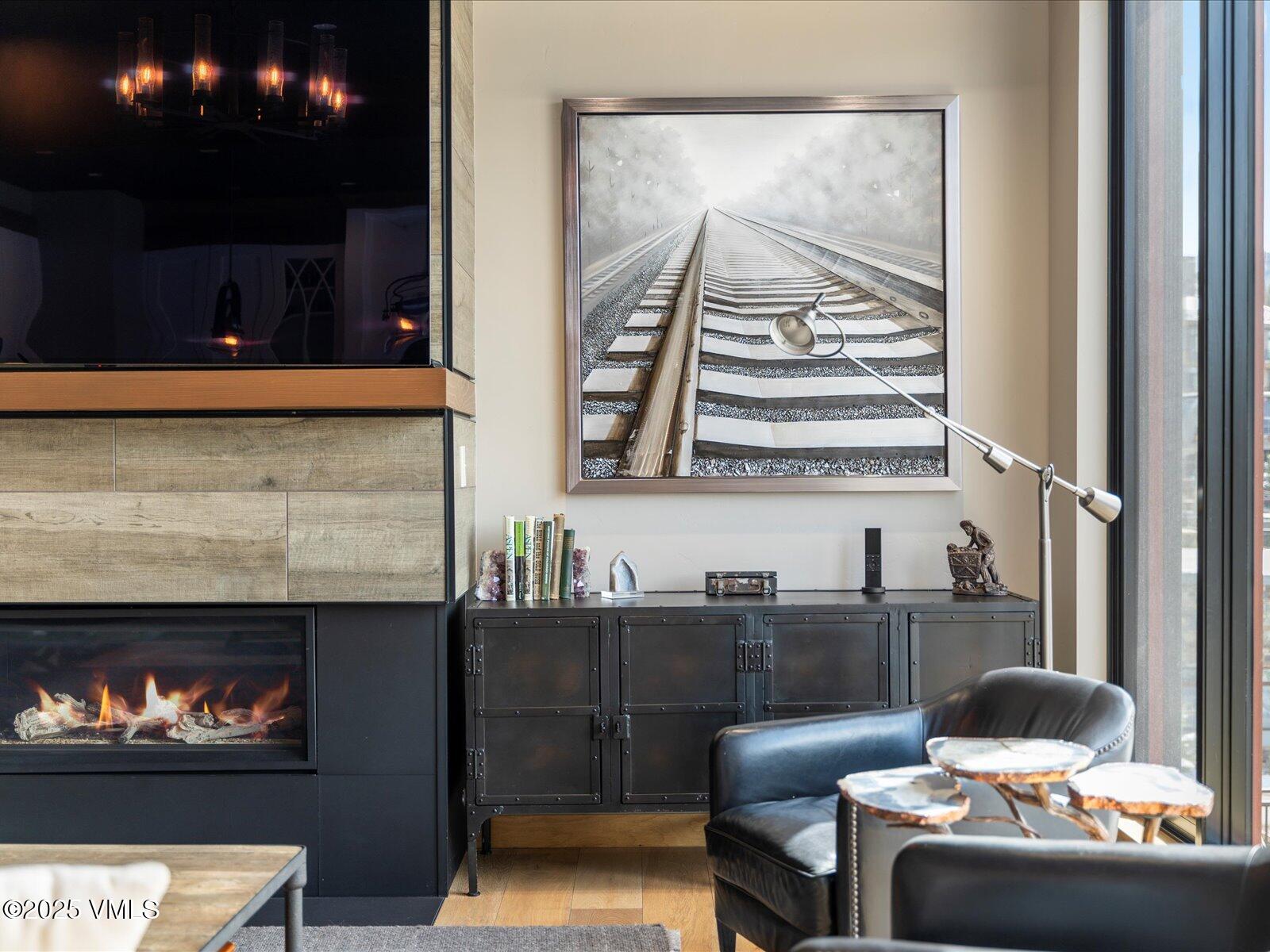 1 Waterfront Way, Unit 204 Avon, CO 81620 - Photo 5 of 38 a living room with furniture and a fireplace