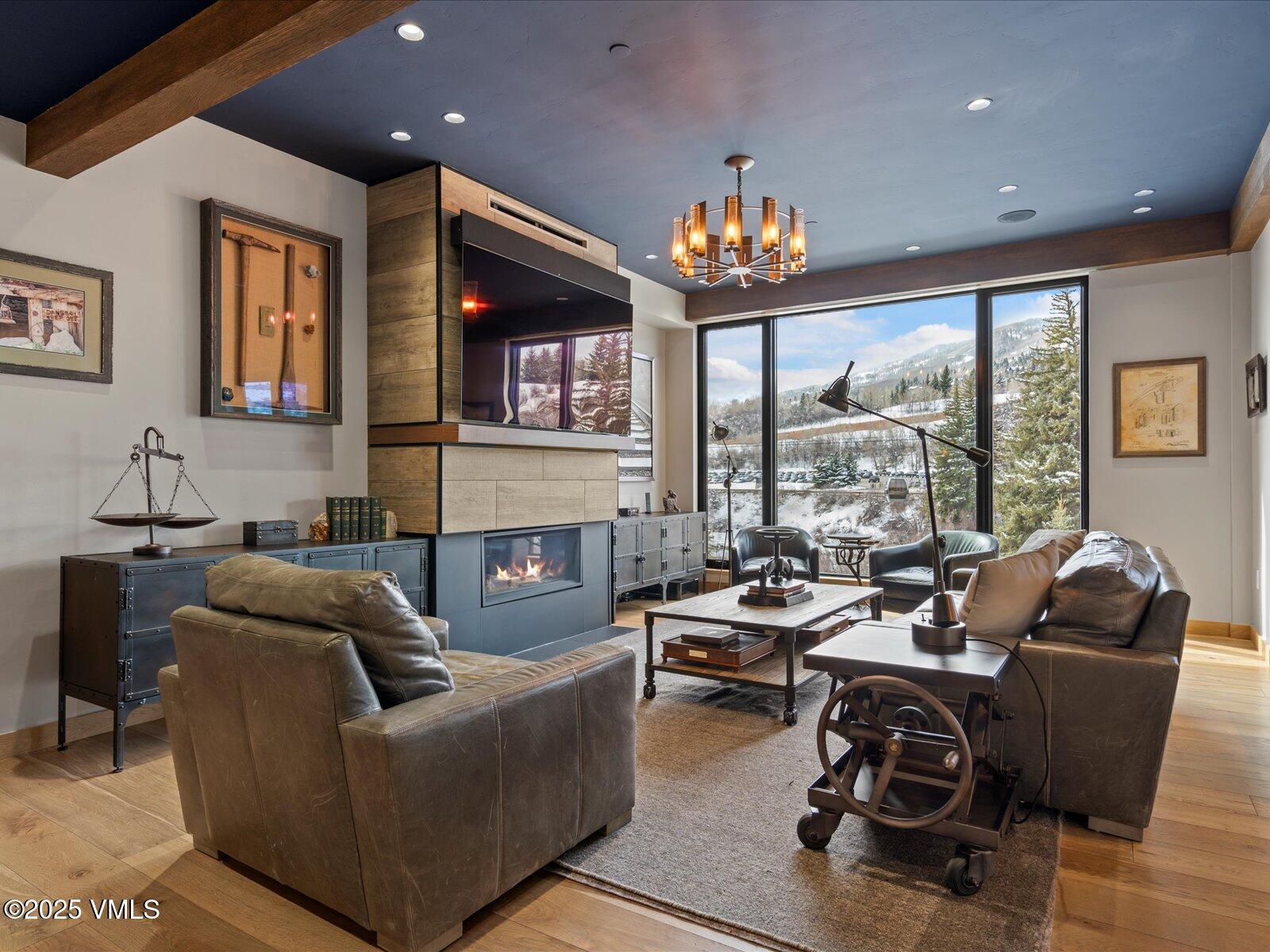 1 Waterfront Way, Unit 204 Avon, CO 81620 - Photo 7 of 38 a living room with furniture fireplace and a large window