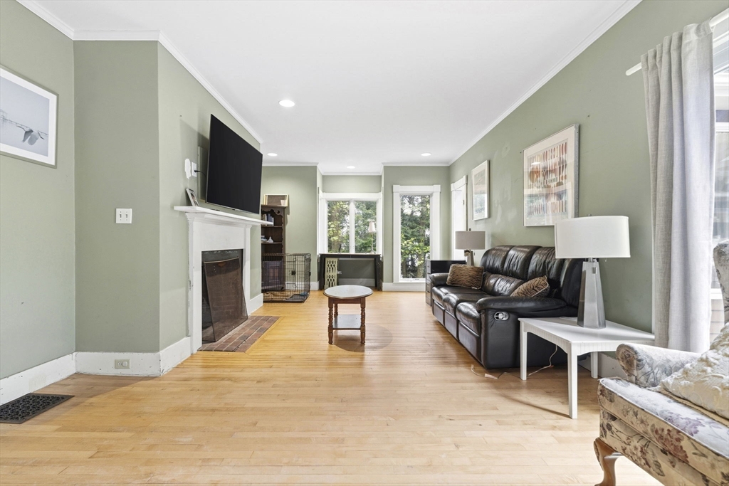 17 Wellesley Street Weston, MA 02493 - Photo 7 of 30 a living room with furniture a fireplace and a flat screen tv