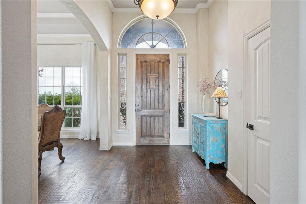 542 Pierce Road Red Oak, TX 75154 - Photo 7 of 27 Grand entryway featuring a distressed wood-finish door with an arched transom, flanked by sidelight windows