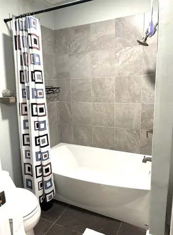 a bathroom with a bathtub and shower