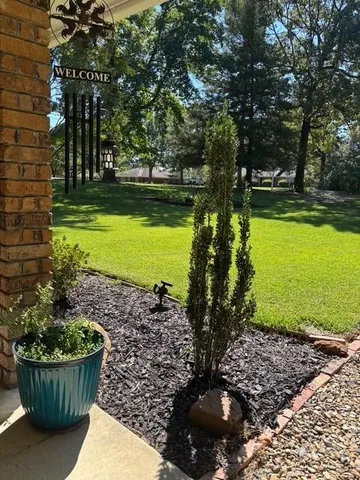 a view of a backyard with swimming pool
