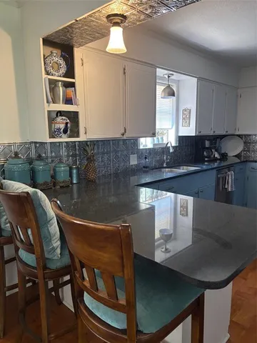 a kitchen with a table chairs stove and cabinets