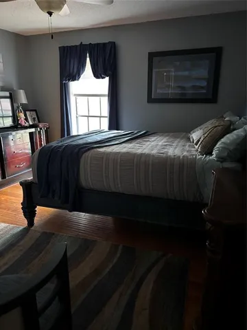 a bedroom with a bed and window