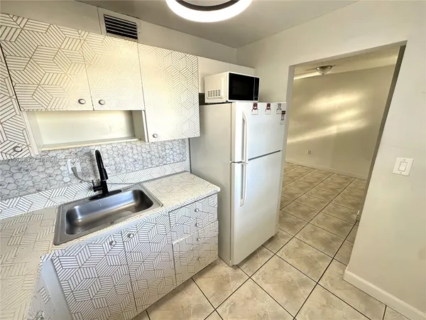 a bathroom with a sink toilet and a mirror