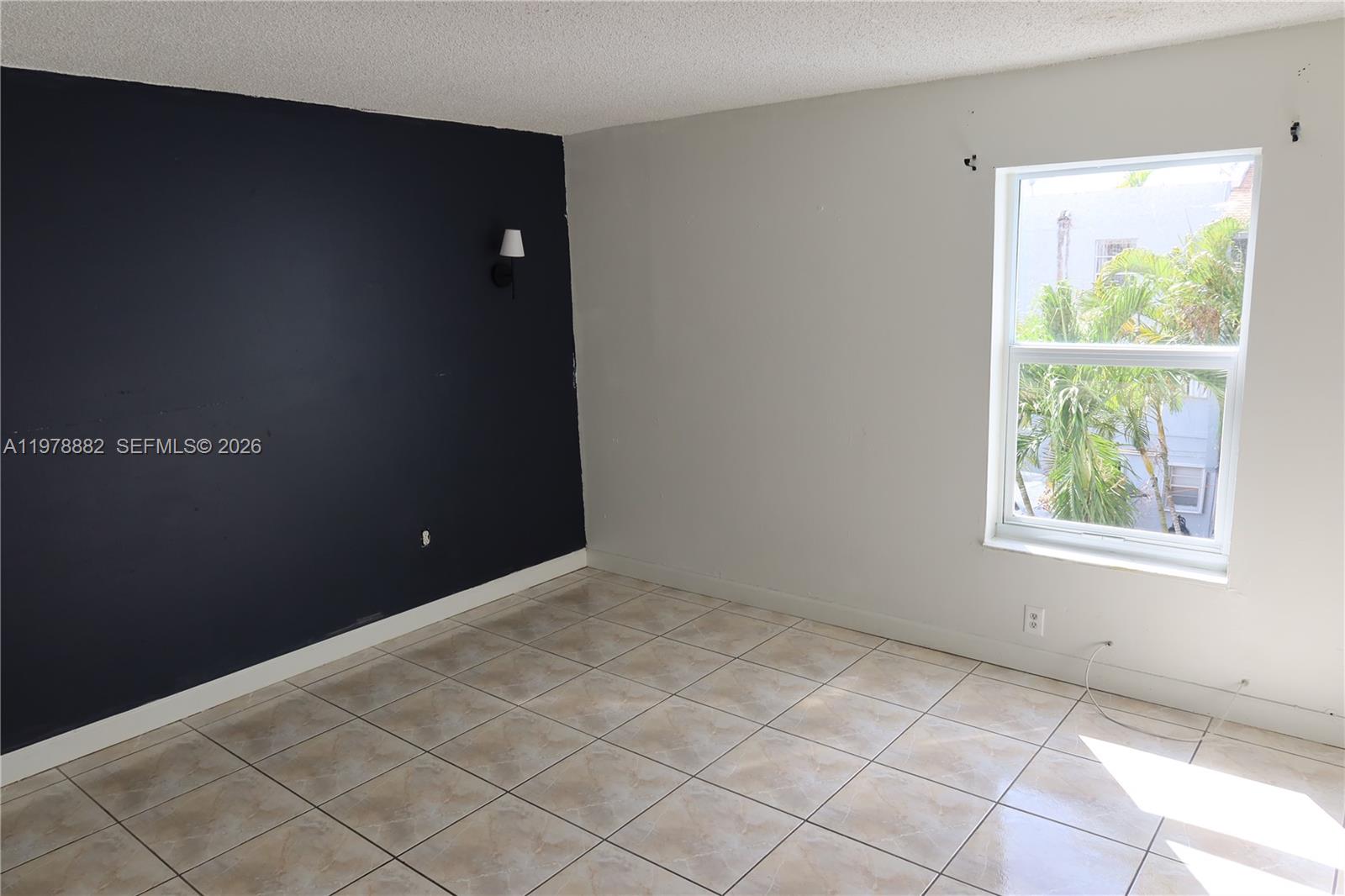1725 West 60th Street, Unit F330 Hialeah, FL 33012 - Photo 10 of 16 a view of an empty room with a window