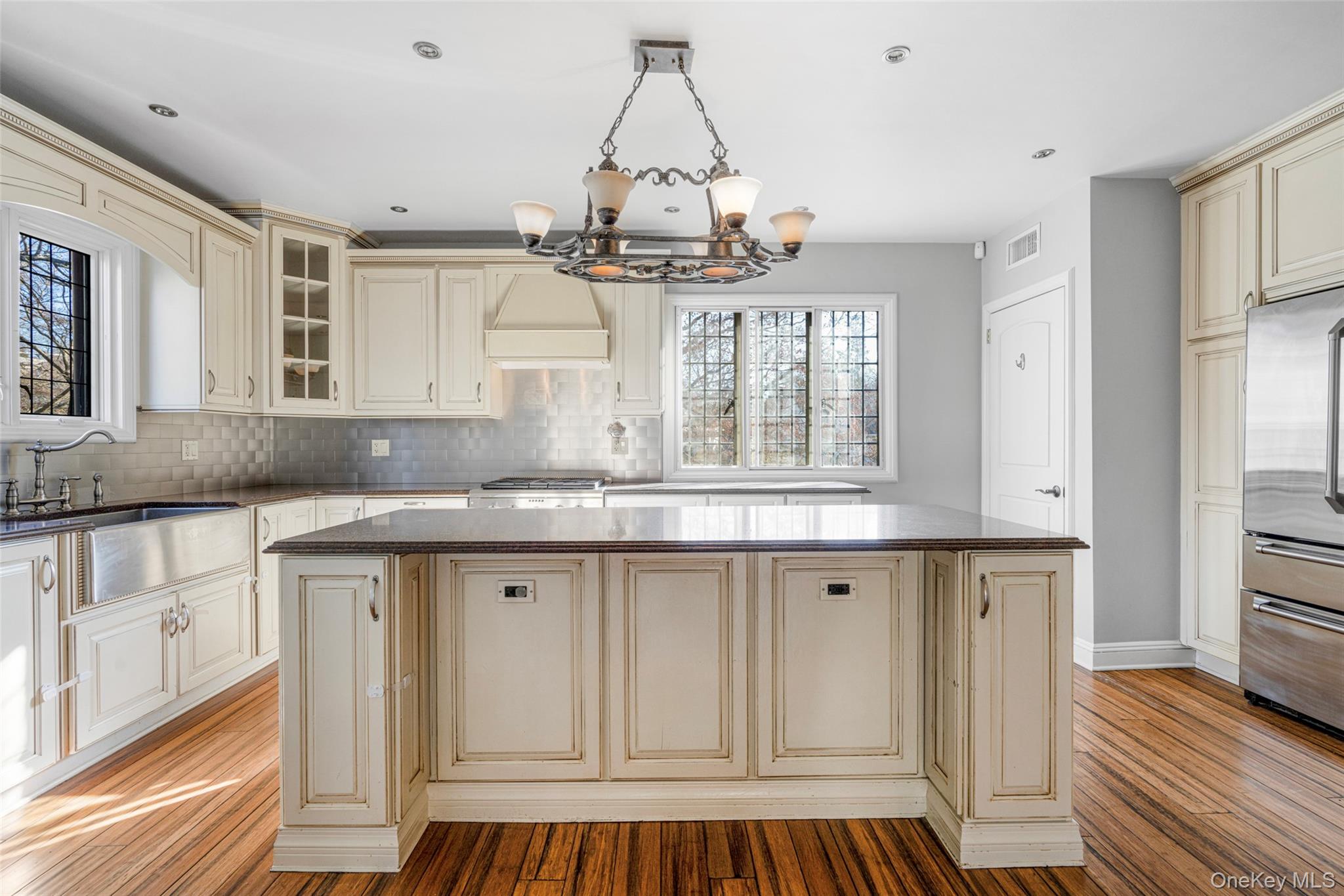 22 Verdun Avenue New Rochelle, NY 10804 - Photo 11 of 31 a kitchen with granite countertop a white cabinets and chandelier