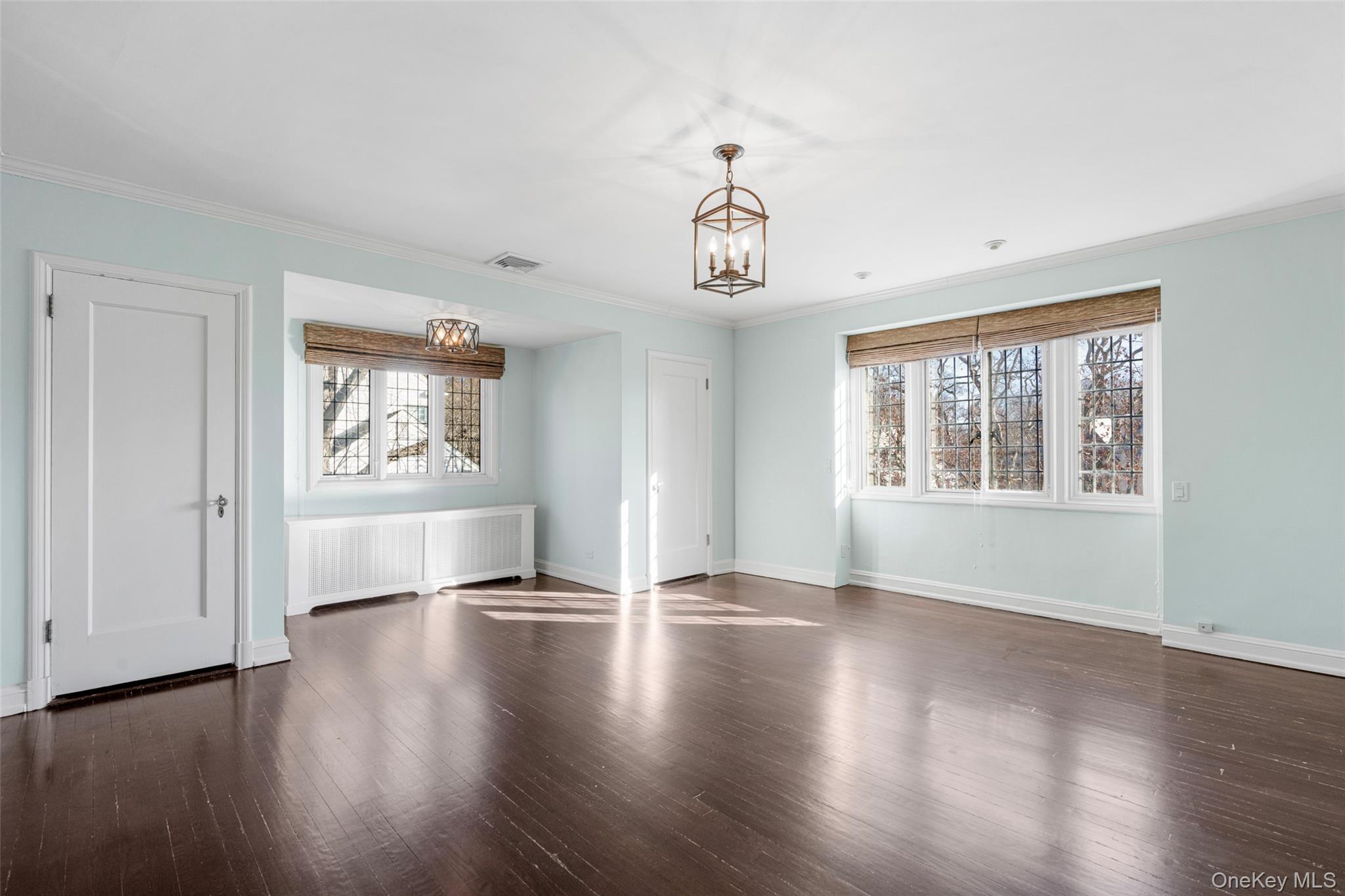 22 Verdun Avenue New Rochelle, NY 10804 - Photo 15 of 31 a view of an empty room with wooden floor and a window