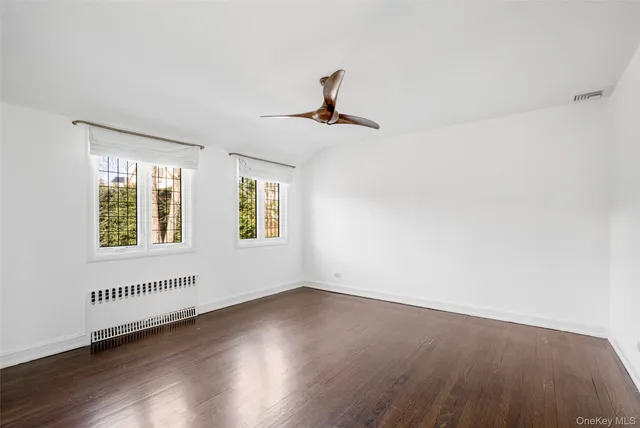 a view of a livingroom with wooden floor and a window