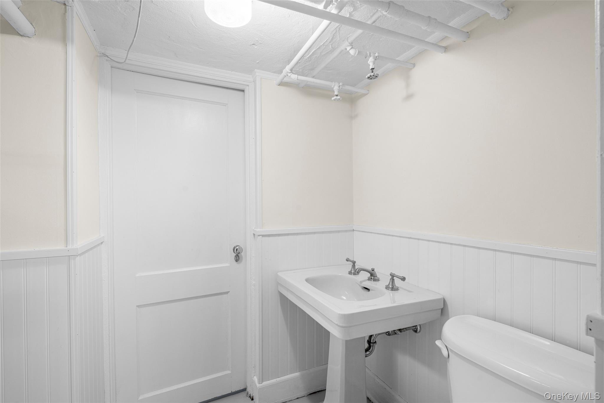 22 Verdun Avenue New Rochelle, NY 10804 - Photo 23 of 31 a bathroom with a sink a toilet and shower