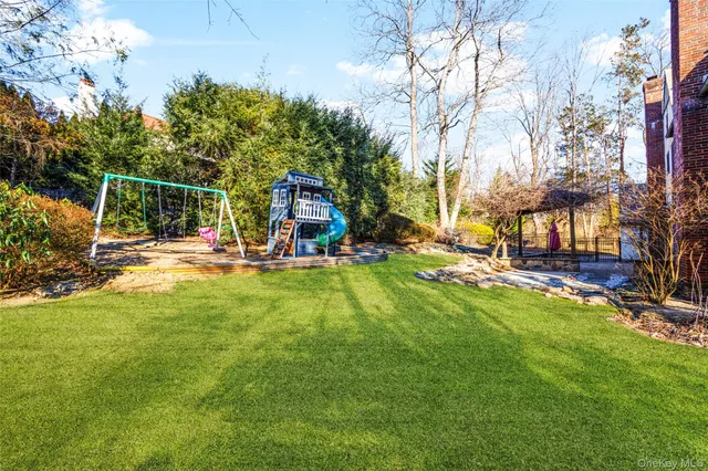 a view of a park with swings and slides