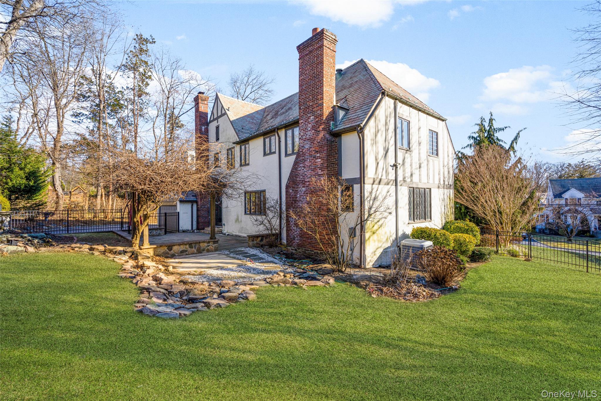 22 Verdun Avenue New Rochelle, NY 10804 - Photo 27 of 31 a backyard of a house with lots of green space table and chairs