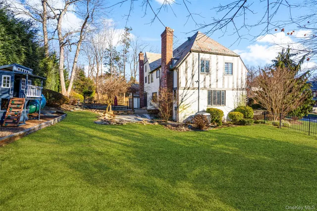 a backyard of a house with lots of green space and fountain