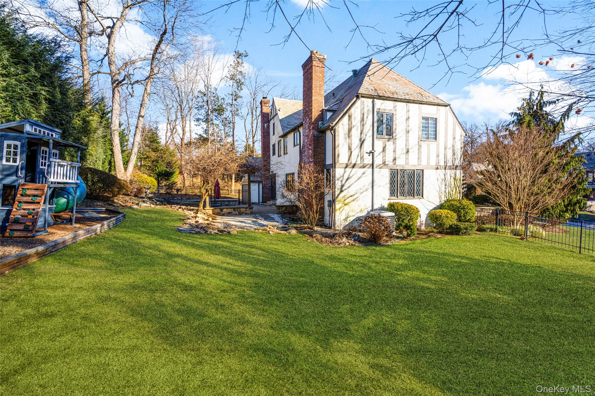 22 Verdun Avenue New Rochelle, NY 10804 - Photo 28 of 31 a backyard of a house with lots of green space and fountain