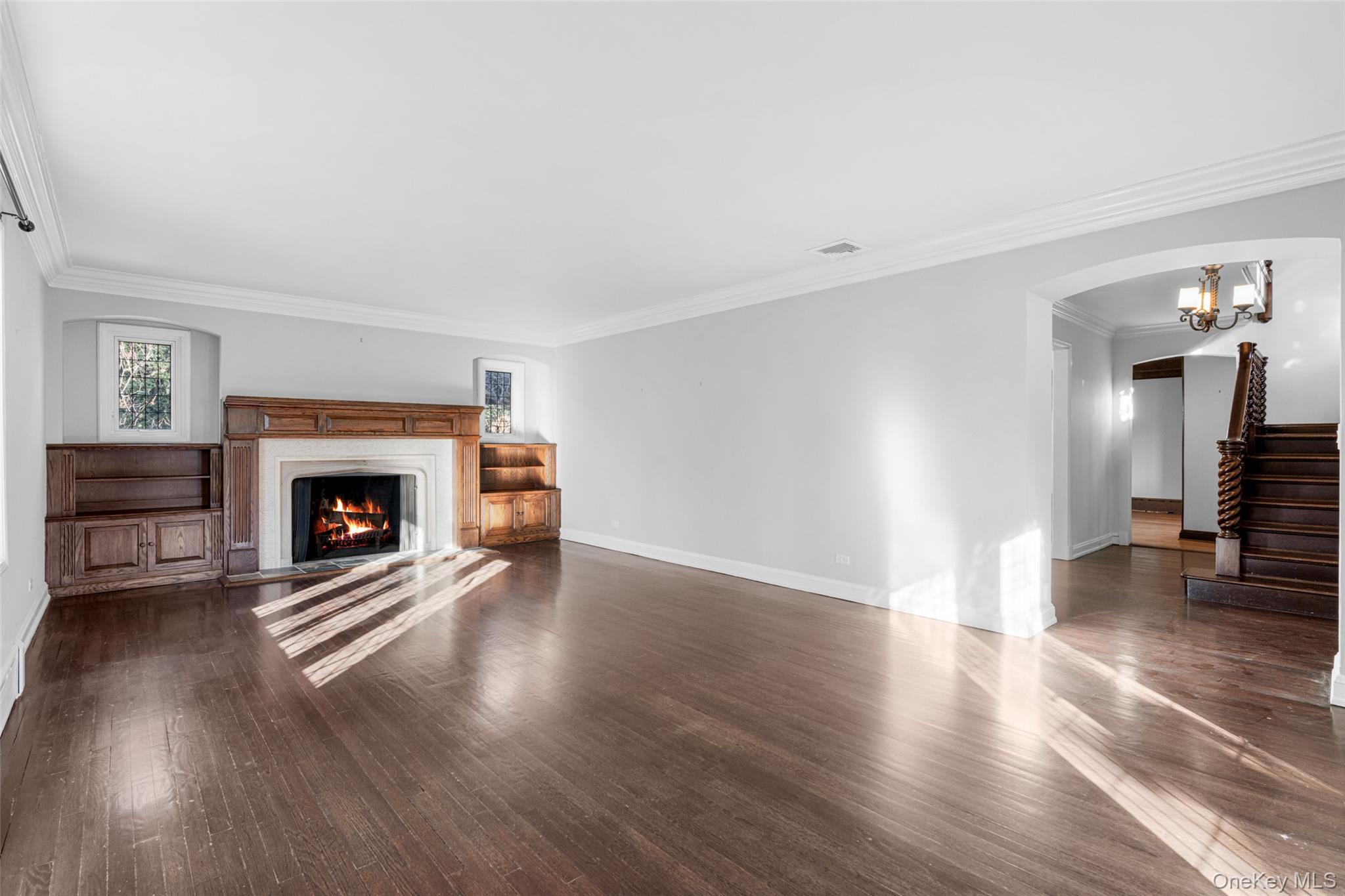 22 Verdun Avenue New Rochelle, NY 10804 - Photo 5 of 31 a view of an empty room with wooden floor fireplace and a window