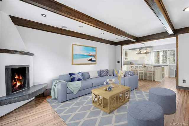 a living room with furniture a fireplace and a table