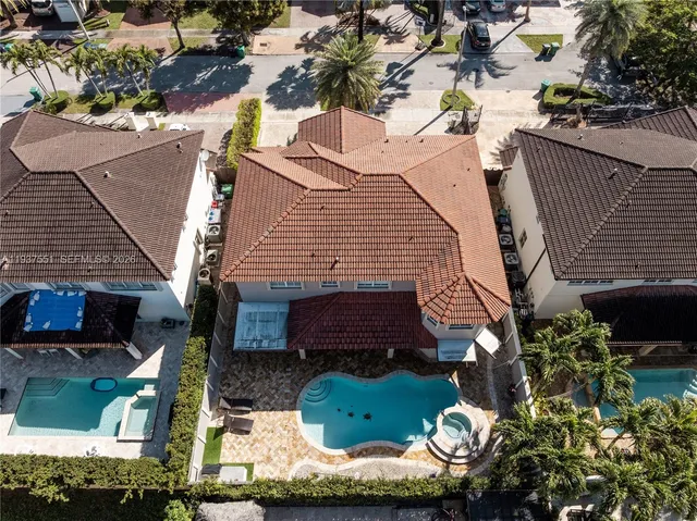 an aerial view of residential houses with outdoor space