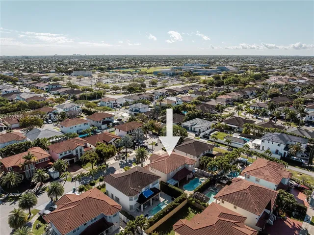 an aerial view of multiple houses with yard