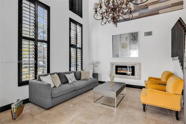 a kitchen with stainless steel appliances granite countertop wooden cabinets a center island and a window