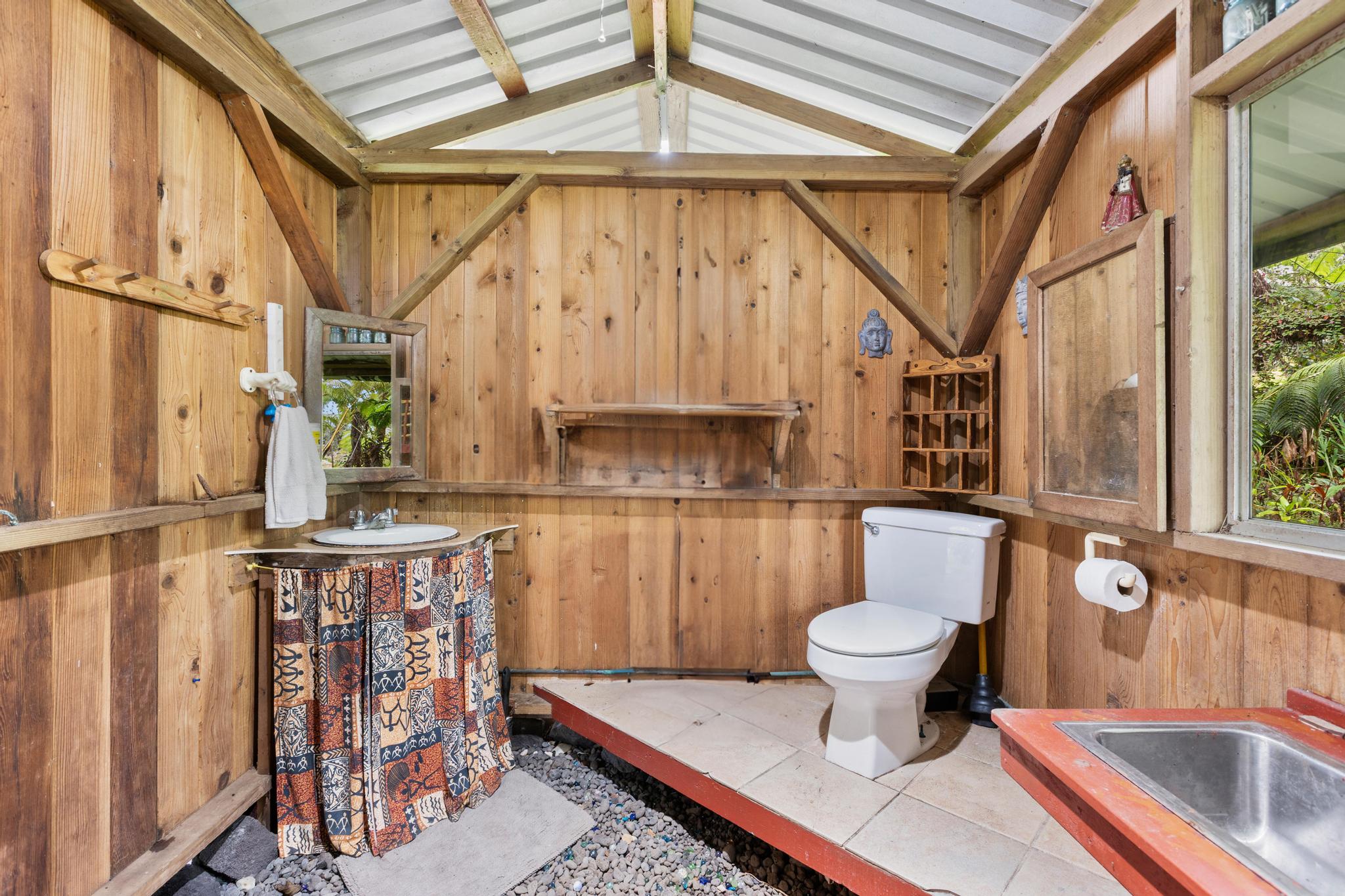 11-2897 Makoa Road Mountain View, HI 96771 - Photo 20 of 30 a bathroom with a toilet a sink and a shower