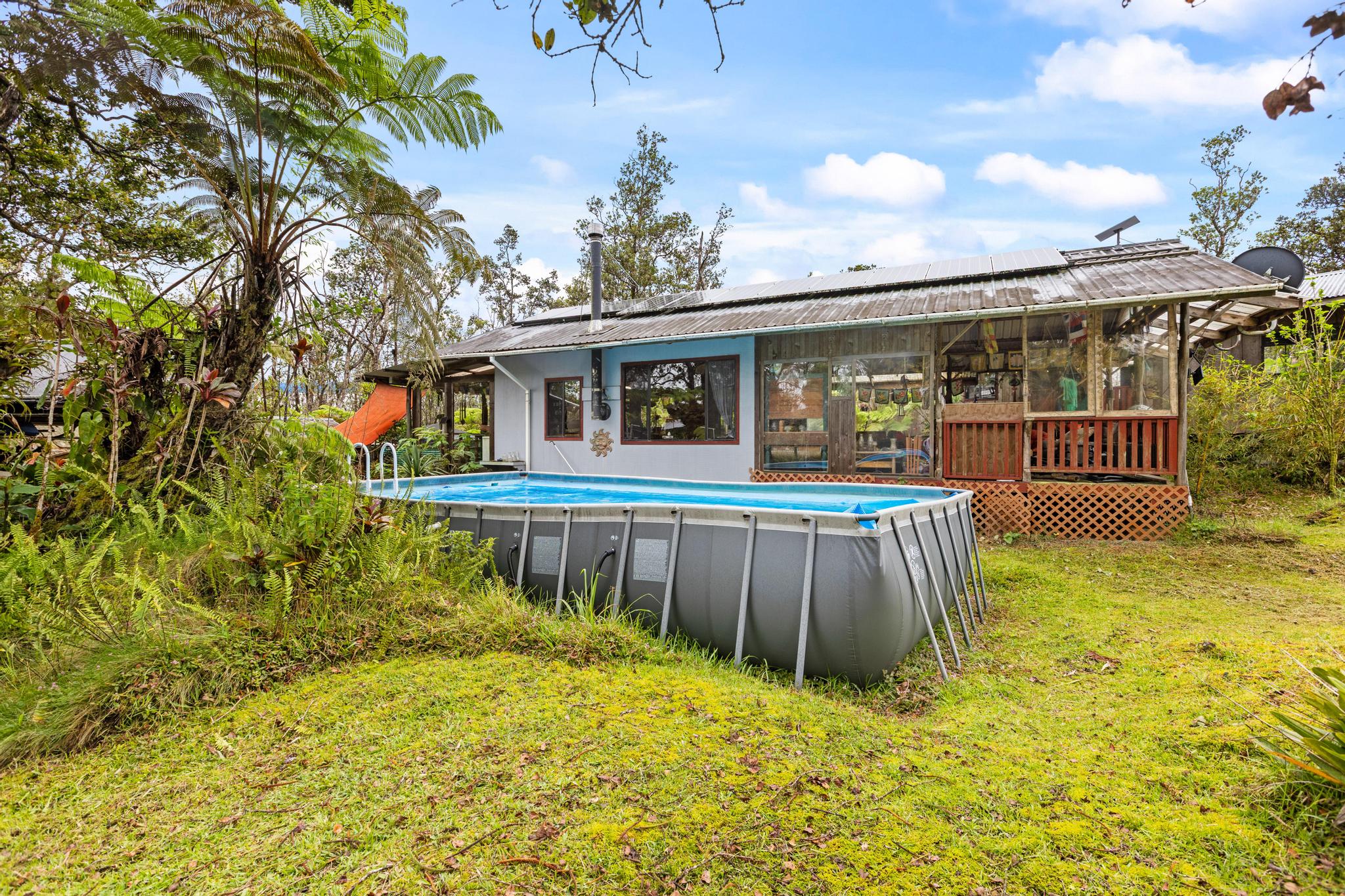 11-2897 Makoa Road Mountain View, HI 96771 - Photo 24 of 30 a view of a house with pool and wooden fence