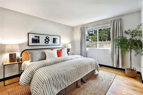 a bedroom with a large bed and a window