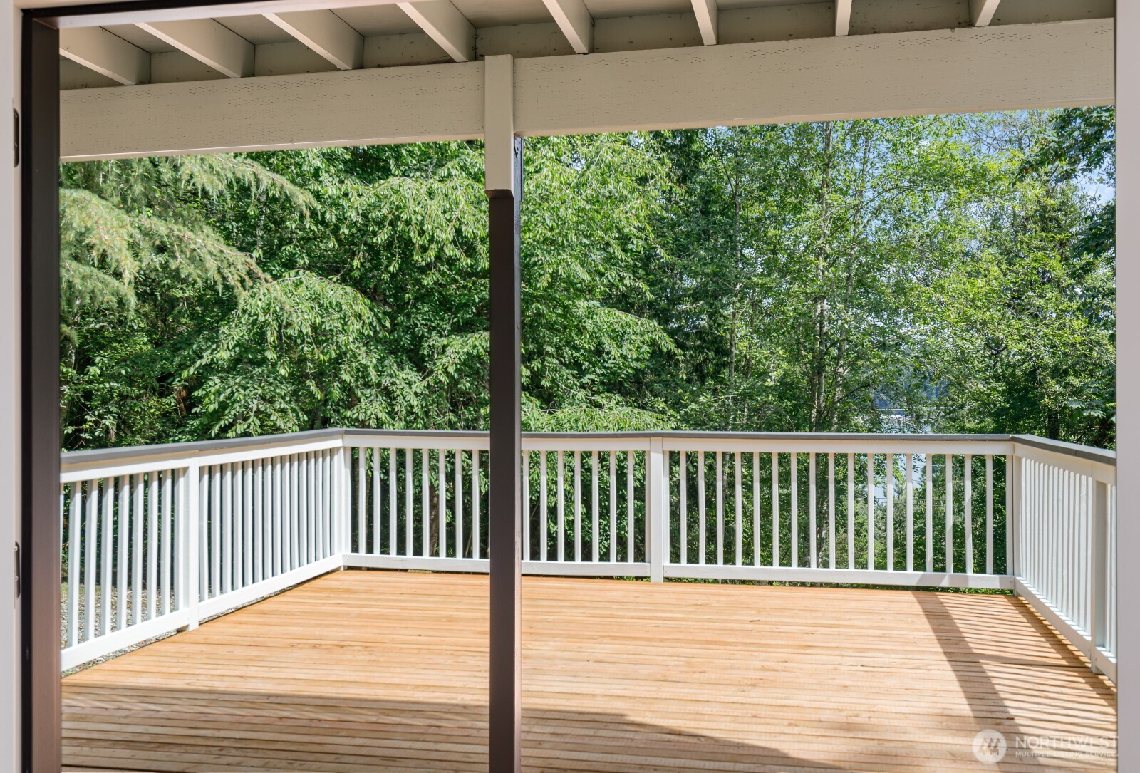 7605 Northeast Hidden Cove Road Bainbridge Island, WA 98110 - Photo 26 of 36 a view of a balcony with wooden floor