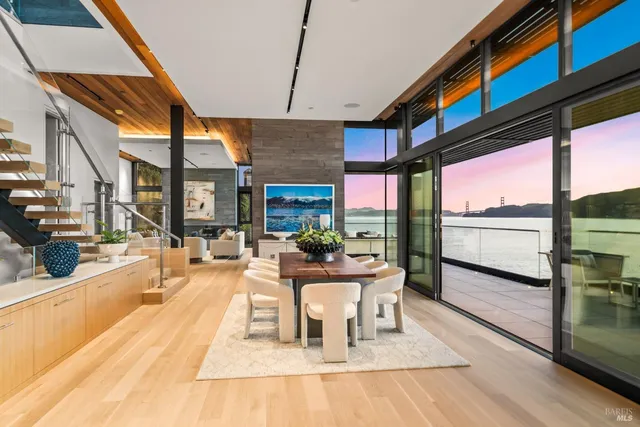 a dining room with furniture a fireplace and wooden floor