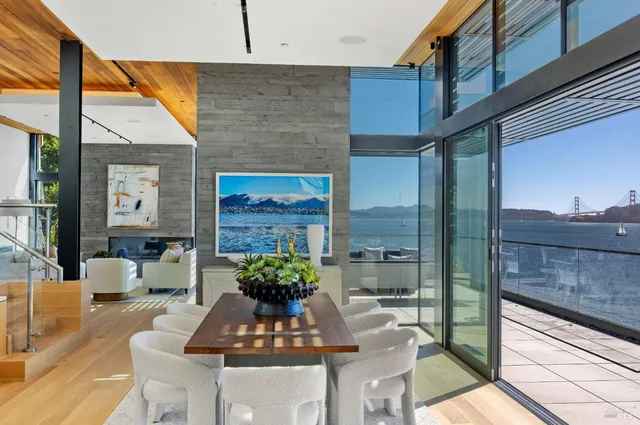 a living room with fireplace furniture and a large window