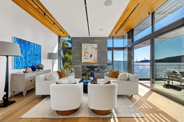 a living room with furniture fireplace and a large window