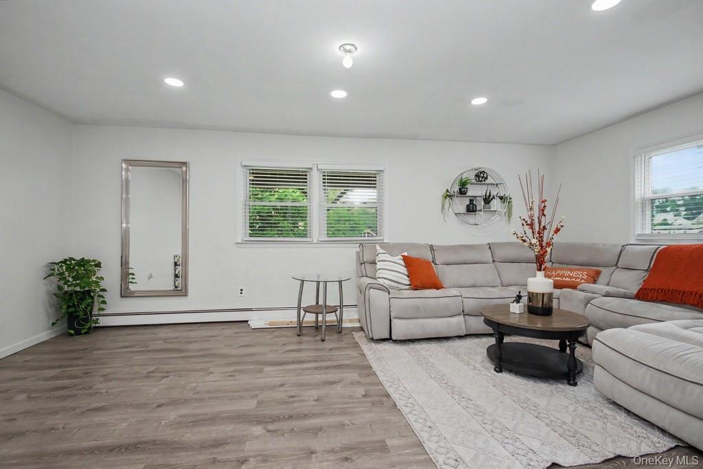 167 Kings Ferry Road Buchanan, NY 10511 - Photo 17 of 26 Spacious family room featuring LVP flooring, recessed lighting, and multiple windows with blinds