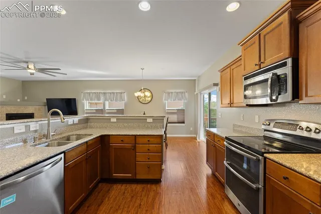 a kitchen with stainless steel appliances granite countertop a sink and stove top oven