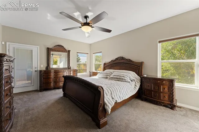 a spacious bedroom with a bed and a chandelier