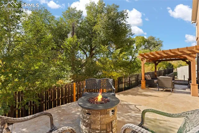 a backyard of a house with table and chairs