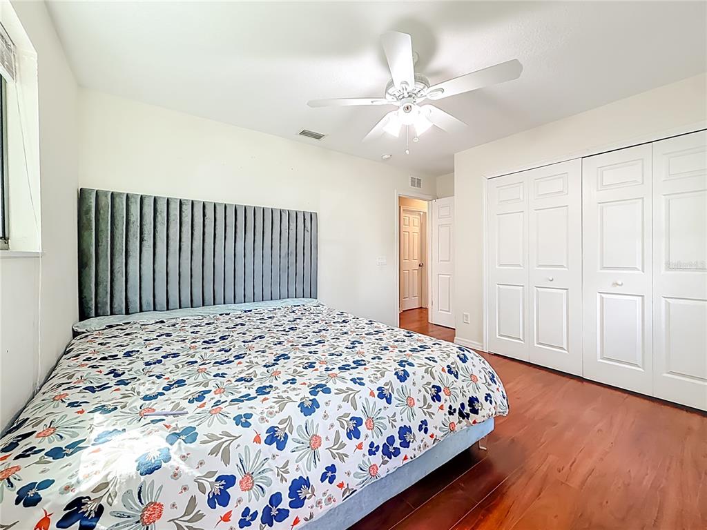 2372 18th Avenue Southwest Largo, FL 33774 - Photo 21 of 80 a bedroom with a large bed and a chandelier