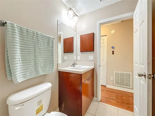 an empty room with wooden floor and ceiling fan