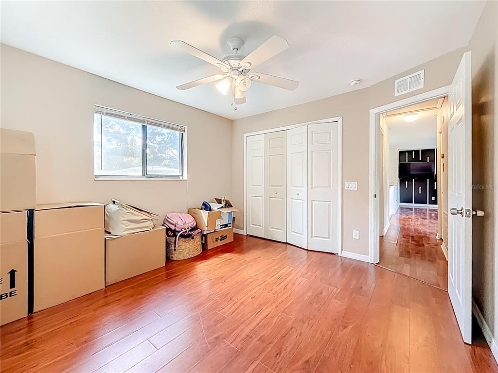 2372 18th Avenue Southwest Largo, FL 33774 - Photo 28 of 80 an empty room with wooden floor fan and windows