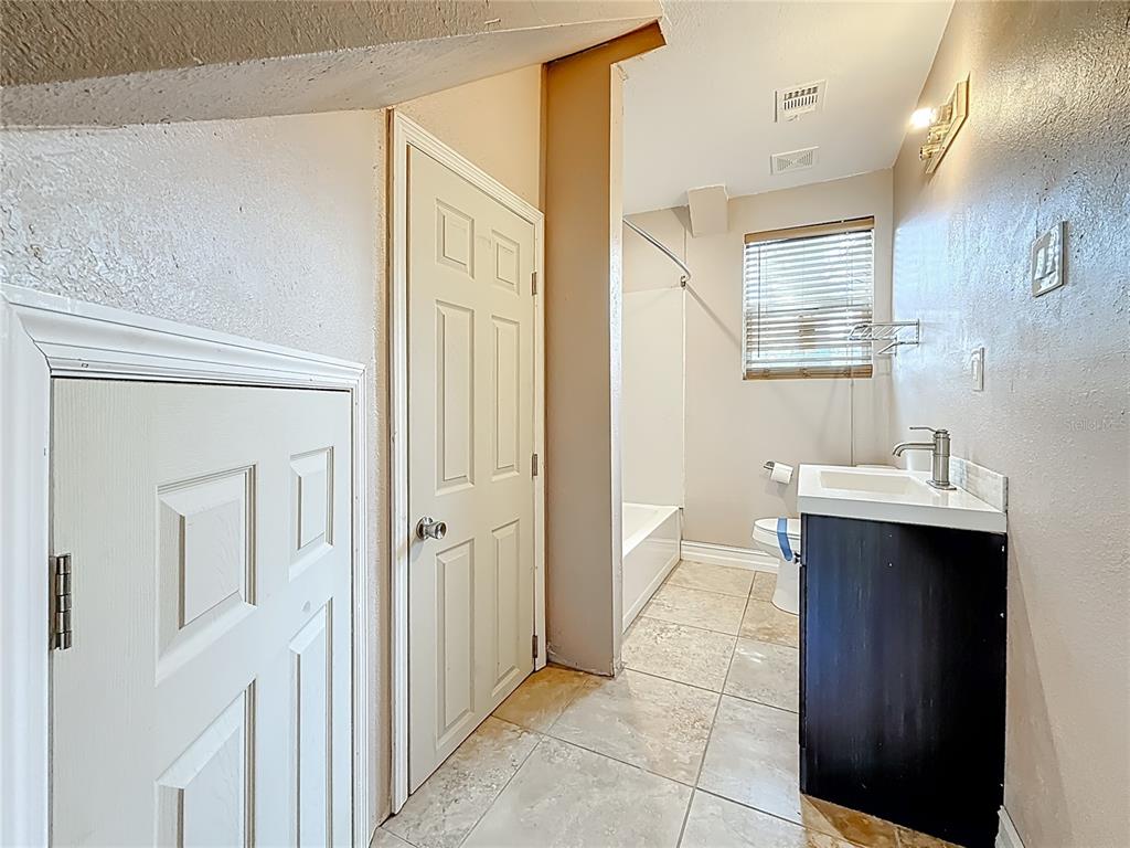 2372 18th Avenue Southwest Largo, FL 33774 - Photo 31 of 80 a bathroom with a sink and mirror with shower