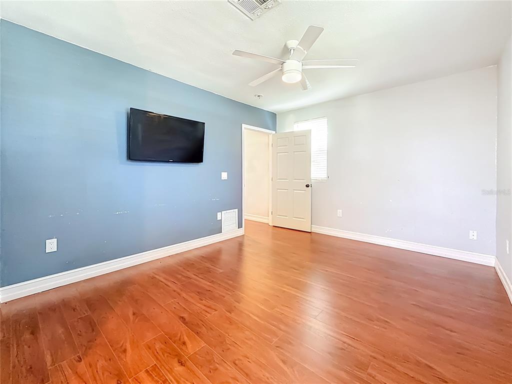 2372 18th Avenue Southwest Largo, FL 33774 - Photo 39 of 80 a view of an empty room with wooden floor and a ceiling fan