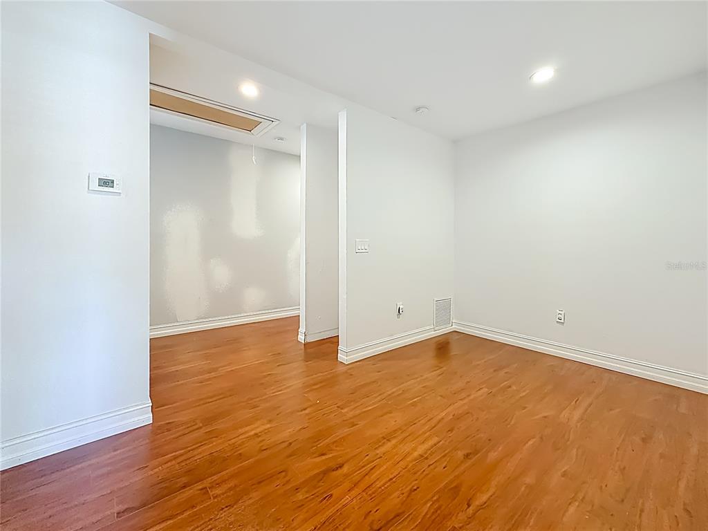 2372 18th Avenue Southwest Largo, FL 33774 - Photo 43 of 80 a view of an empty room with wooden floor and a window