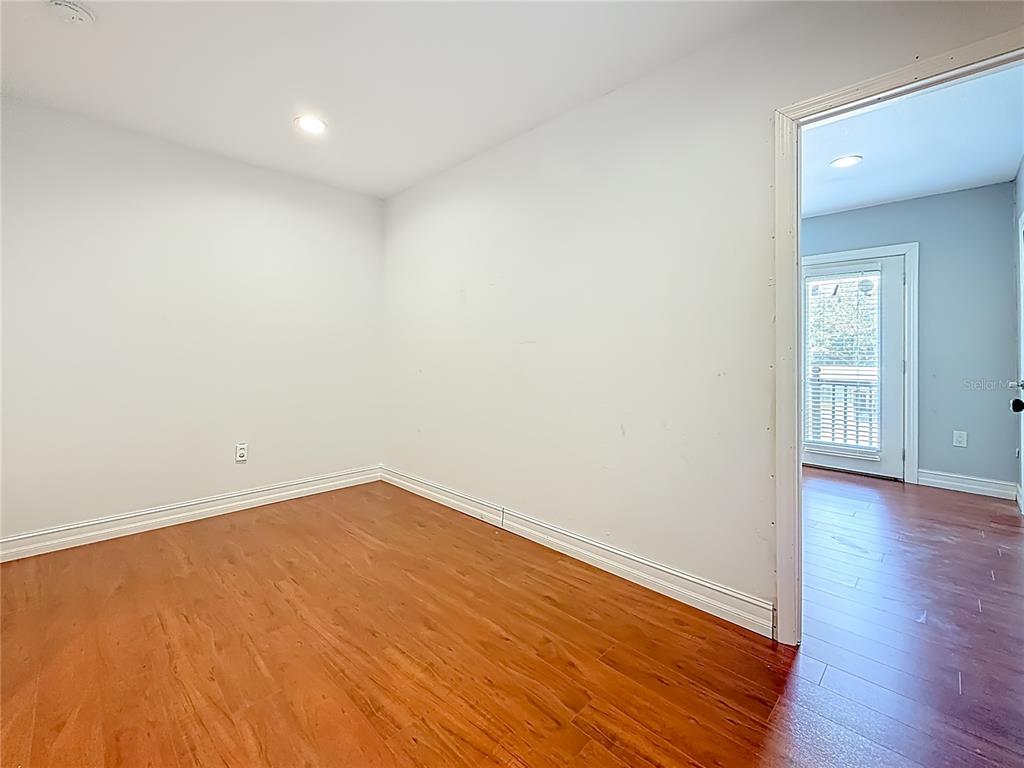 2372 18th Avenue Southwest Largo, FL 33774 - Photo 44 of 80 an empty room with wooden floor and windows