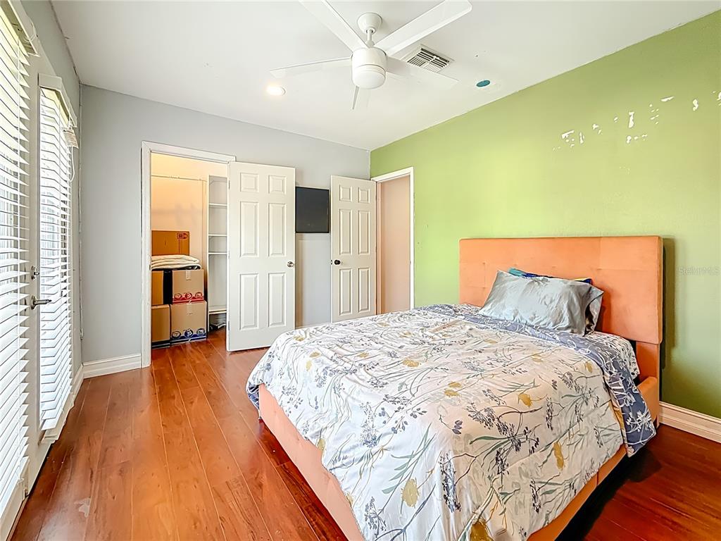 2372 18th Avenue Southwest Largo, FL 33774 - Photo 48 of 80 a spacious bedroom with a bed and a walk in closet